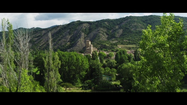 Video Reference: Sky, Mountain, Cloud, Plant, Natural landscape, Land lot, Terrain, Building, Grass, Rectangle