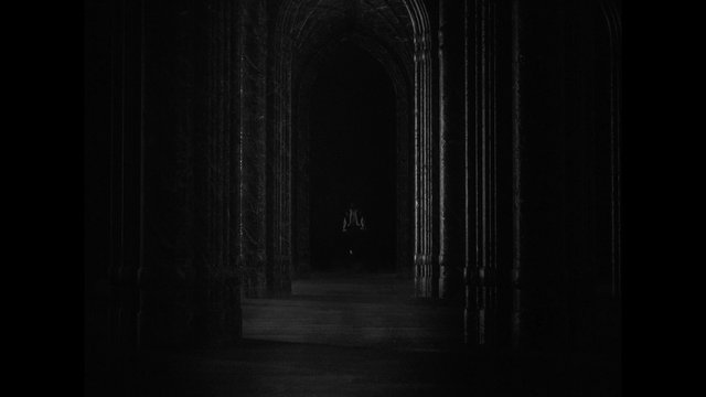 Video Reference: dark, monochrome, corridor, arches, hallway, shadowy, mysterious, gothic, interior, tunnel, distant figure, low light