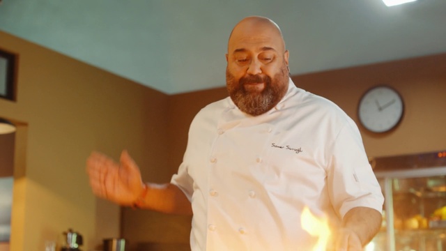 Video Reference: Beard, Gesture, Clock, Smile, Chefs uniform, Chef, Cooking, T-shirt, Event, Moustache