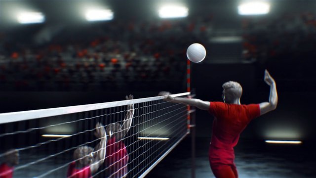 Video Reference: volleyball, indoor court, sports, player, net, spike, block, ball, team game, arena, competition, red uniform, jumping, action, spectators, lighting