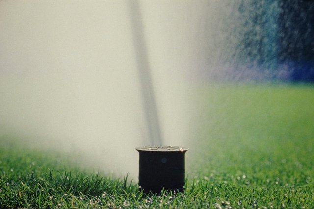 Video Reference: sprinkler, irrigation, water spray, grass, lawn, outdoor, watering, field, landscape, green, garden, hose, water jet, maintenance