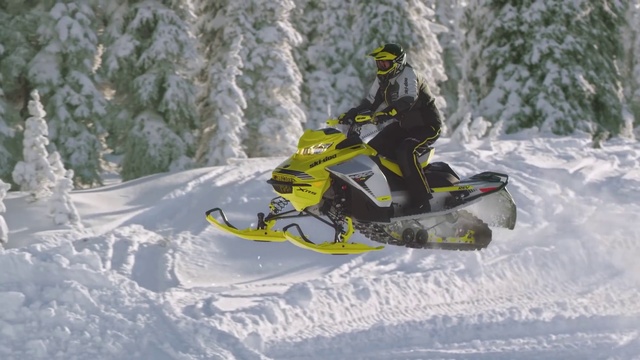 Video Reference: Snowmobile, Snow, Helmet, Sports equipment, Vehicle, Automotive tire, Slope, Tree, Sports gear, Motorsport
