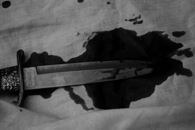Video Reference: dagger, knife, blade, blood, stain, fabric, close-up, black and white, weapon, murder, crime scene, dramatic, still life, old film