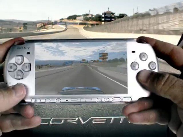 Video Reference: handheld console, gaming, driving game, road, car interior, hands, screen, portable device, video game, vehicle, dashboard, outdoors, motion, controller, technology