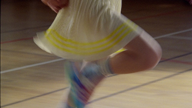 Video Reference: Arm, Human body, Knee, Sportswear, Flooring, Human leg, Fashion design, Wood, Electric blue, Foot