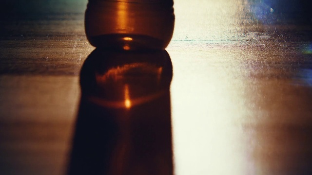 Video Reference: Brown, Drinkware, Liquid, Bottle, Light, Glass bottle, Amber, Fluid, Bottle stopper & saver, Wood