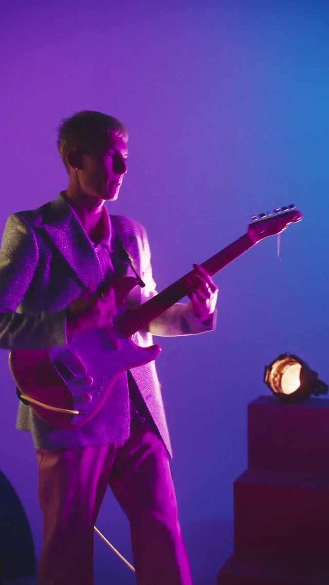 Video Reference: Musical instrument, String instrument, Purple, Musician, Guitar, Human, String instrument, Guitar accessory, Concert, Entertainment