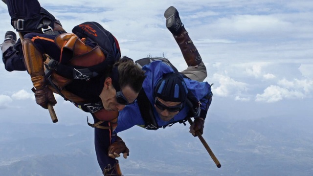 Video Reference: Cloud, Tandem skydiving, Sky, Glove, Helmet, Sports equipment, Stunt performer, Happy, Rope, Electric blue