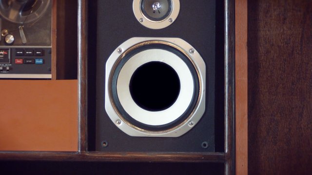 Video Reference: speaker, stereo, cassette deck, audio equipment, wood cabinet, close-up, vintage, electronics, speaker grille, control panel, interior, retro