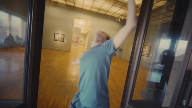 Video Reference: Standing, Architecture, Gesture, Wood, Floor, T-shirt, Glass, Flooring, Fun, Sportswear