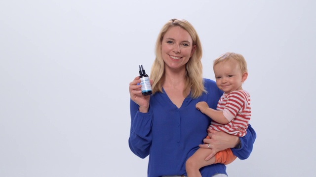 Video Reference: Hair, Smile, Shoulder, Human body, Sleeve, Bottle, Happy, Gesture, Plastic bottle, Finger