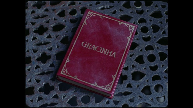 Video Reference: Rectangle, Textile, Pink, Font, Violet, Material property, Magenta, Pattern, Wallet, Electric blue