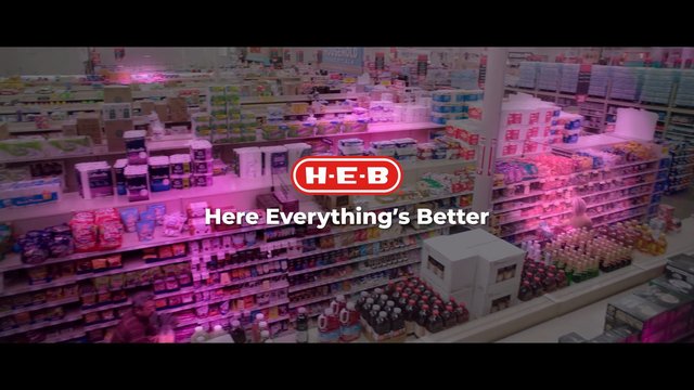 Video Reference: grocery store, supermarket, aisle, shelves, retail, household products, store interior, shopping, branding, logo, advertisement, product display, consumer goods, wide shot