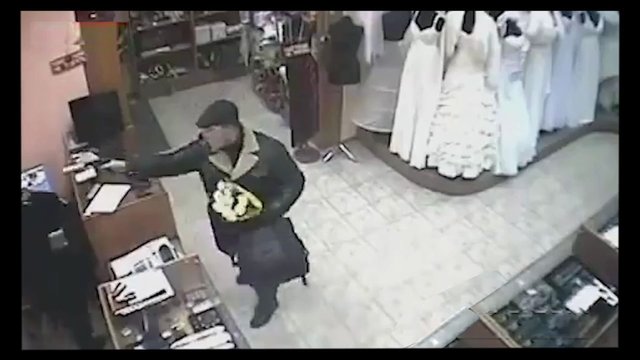 Video Reference: surveillance, retail store, shop interior, person, counter, clothing, dresses, indoor, security camera, fashion, standing, reaching