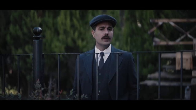 Video Reference: Hat, Dress shirt, Tie, Sleeve, Flash photography, Standing, Beard, Fence, Blazer, Street fashion