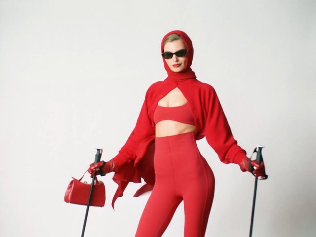 Video Reference: fashion, model, red outfit, sunglasses, headscarf, studio, white background, pose, handbag, ski poles, runway style, editorial, minimalist, luxury fashion, full body