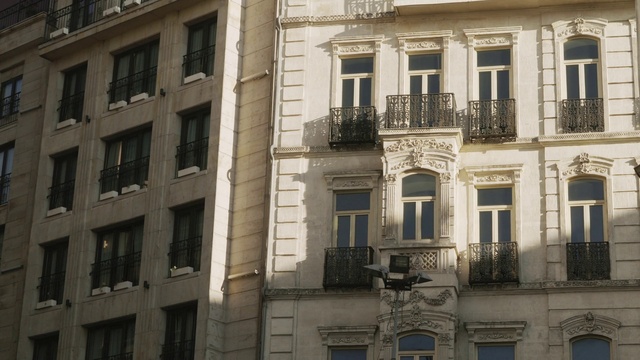 Video Reference: Window, Building, Property, Neighbourhood, Material property, City, Facade, Landmark, Monochrome, Human settlement