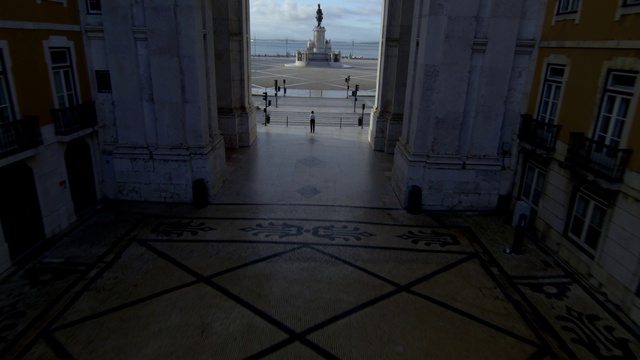 Video Reference: Building, Door, Floor, Flooring, Road surface, Symmetry, City, Facade, Window, Column
