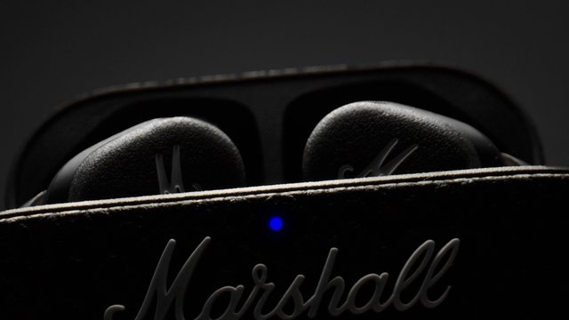 Video Reference: speaker, audio device, marshall, close-up, dark background, blue light, electronics, sound equipment, black device