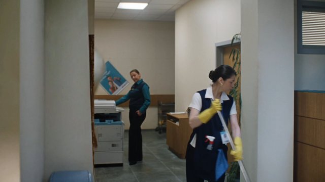 Video Reference: office, hallway, cleaning, janitor, mopping, cleaning staff, indoor, workplace, copy machine, corridor, maintenance, uniform, gloves, commercial interior, service, custodial