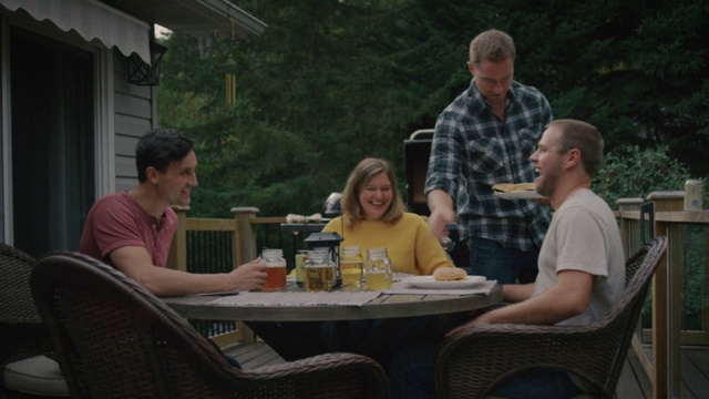 Video Reference: Table, Tableware, Smile, Sharing, Chair, Outdoor furniture, Outdoor table, Bottle, Interaction, Leisure