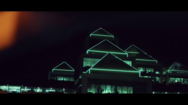 Video Reference: Sky, Building, Electricity, Triangle, Rectangle, Font, Facade, City, Midnight, Neon