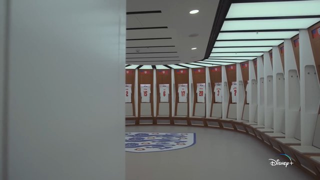 Video Reference: locker room, sports, jerseys, soccer, football, team, stadium, interior, curved corridor, lockers, crest, white jerseys, modern, empty room, indoor, arena