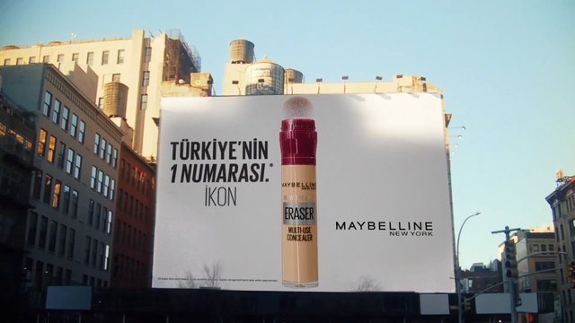 Video Reference: billboard, advertisement, city street, urban, buildings, sky, Maybelline, cosmetics, concealer, Turkish text, outdoor, street scene, large sign, daytime