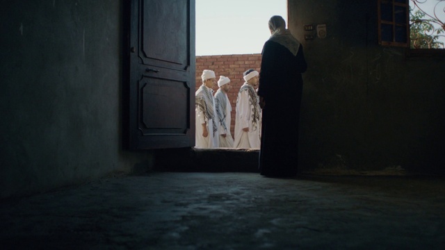 Video Reference: Window, Gesture, Door, Flooring, Tints and shades, Road surface, Wood, Art, Formal wear, Tree