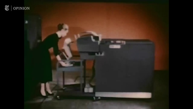 Video Reference: Output device, Office equipment, Wood, Table, Desk, Font, Display device, Gadget, Event, Human leg