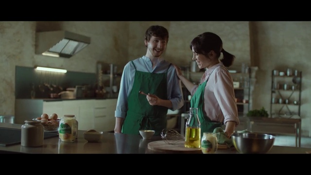 Video Reference: Tableware, Table, Countertop, Apron, Bottle, Cooking, Drinkware, Kitchen, Smile, T-shirt