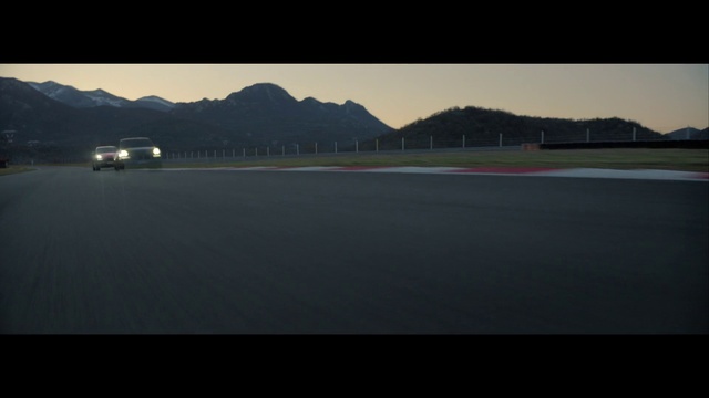 Video Reference: Sky, Mountain, Asphalt, Water, Vehicle, Car, Road, Horizon, Tints and shades, Landscape