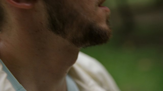 Video Reference: close-up, man, beard, neck, profile, outdoor, blurred background, shallow depth of field, face, skin, green background, portrait