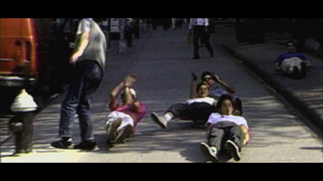 Video Reference: Road surface, Road, City, Event, Asphalt, Sitting, Pedestrian, Sidewalk, Fun, Street