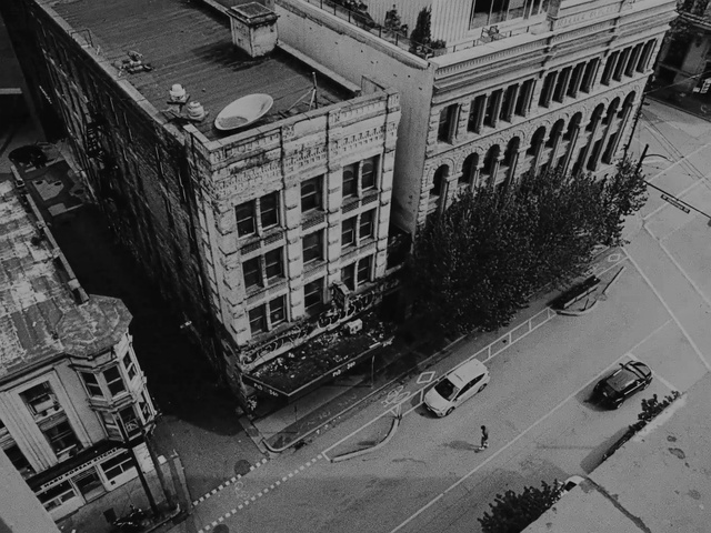 Video Reference: Building, Window, Car, White, Infrastructure, Black, Black-and-white, Neighbourhood, Motor vehicle, Urban design