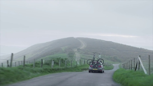 Video Reference: Tire, Wheel, Sky, Vehicle, Plant, Ecoregion, Mountain, Bicycle, Road surface, Asphalt