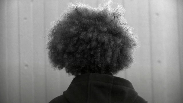 Video Reference: rear view, person, curly hair, hoodie, black and white, portrait, silhouette, indoor, back of head, minimal background