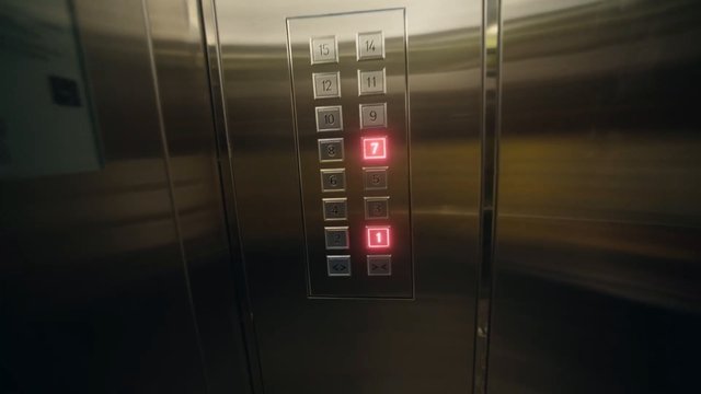Video Reference: elevator, lift, control panel, buttons, floors, stainless steel, interior, indoor, transportation, metal, indicator lights, numbered buttons