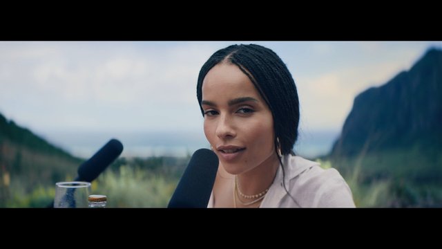 Video Reference: woman, microphone, outdoor, close-up, interview, podcast, mountains, nature, glass, bottle, speaking, portrait, daylight, scenic