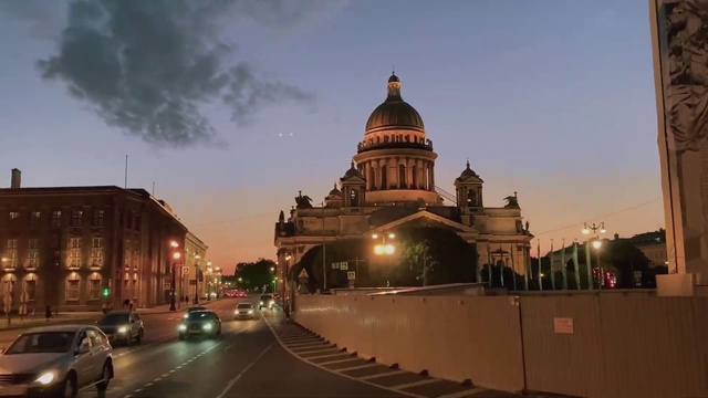 Video Reference: Sky, Cloud, Building, Street light, Dusk, City, Road surface, Facade, Landmark, Metropolitan area