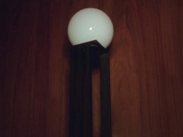 Video Reference: Lamp, Wood, Audio equipment, Tints and shades, Hardwood, Wood stain, Flooring, Table, Circle, Ceiling fixture