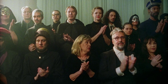 Video Reference: Face, Head, Hand, Outerwear, Organ, Human, Fashion, Coat, Gesture, Beard