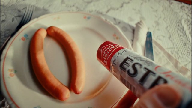 Video Reference: sausage, mustard, plate, close-up, food, meal, table setting, breakfast, condiment, cooking, eating, kitchen, snack