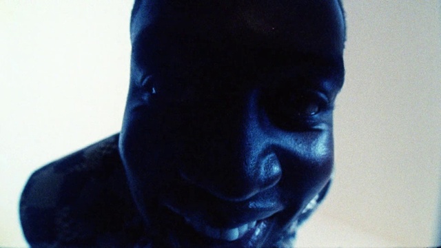 Video Reference: Neck, Jaw, Flash photography, Sleeve, Cap, Electric blue, Beard, Art, Eyewear, Facial hair