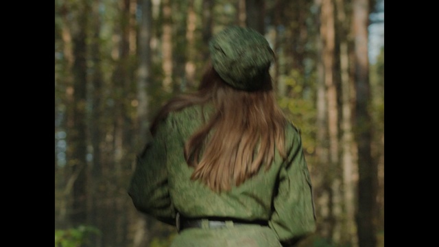 Video Reference: Outerwear, People in nature, Sleeve, Wood, Cap, Tree, Street fashion, Woody plant, Grass, Trunk