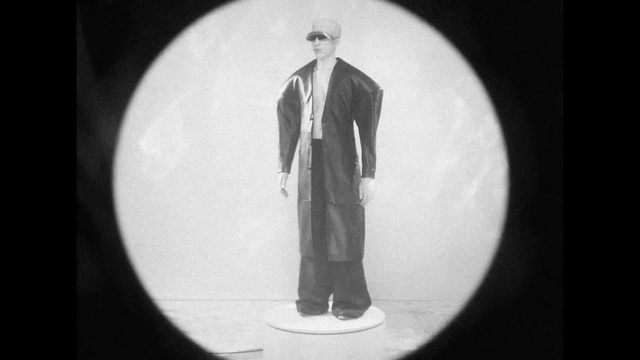 Video Reference: Sleeve, Flash photography, Gesture, Black-and-white, Style, Blazer, Formal wear, Entertainment, Monochrome photography, Suit