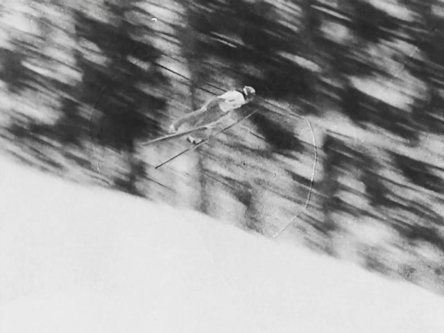Video Reference: skiing, skier, snow, jump, winter, sports, motion blur, black and white, slope, trees, outdoor, action