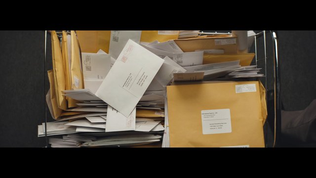Video Reference: mail, envelopes, paperwork, documents, office, postal, stacked, cart, filing, business, correspondence, shipping, storage, messy, indoor