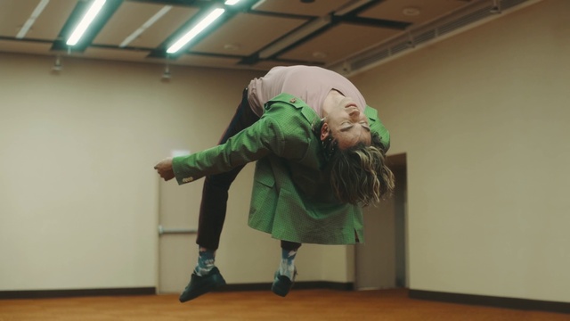 Video Reference: Sleeve, Flooring, Floor, Performing arts, Entertainment, Event, Hardwood, Dance, Sock, Costume
