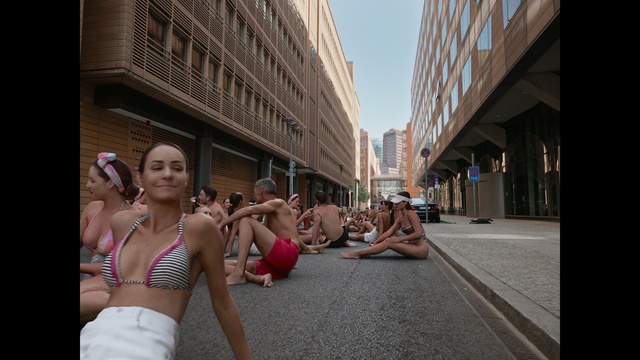 Video Reference: Building, Leg, Brassiere, Thigh, Travel, Road surface, Road, Navel, City, Swimwear